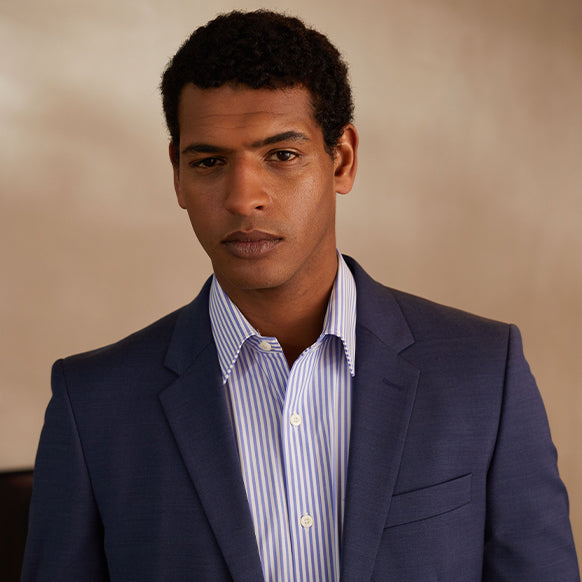 Men's navy suit with striped shirt