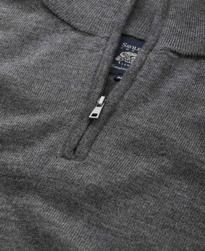 Close-up of a dark gray ribbed knit half-zip sweater with a silver zipper pull and a visible Savile brand neck label.
